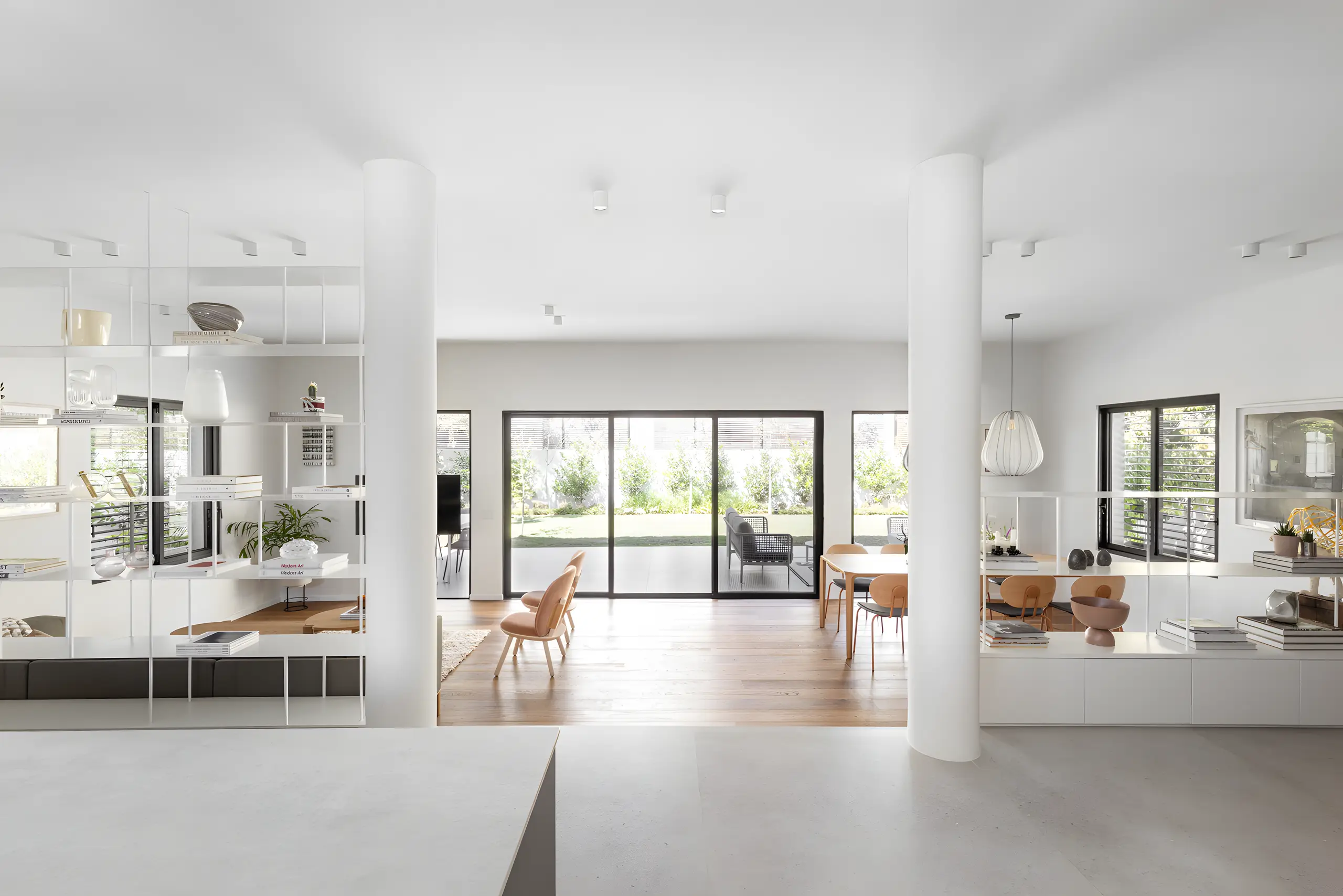 Living room on oak with leather armchairs and full-height glazing to the garden