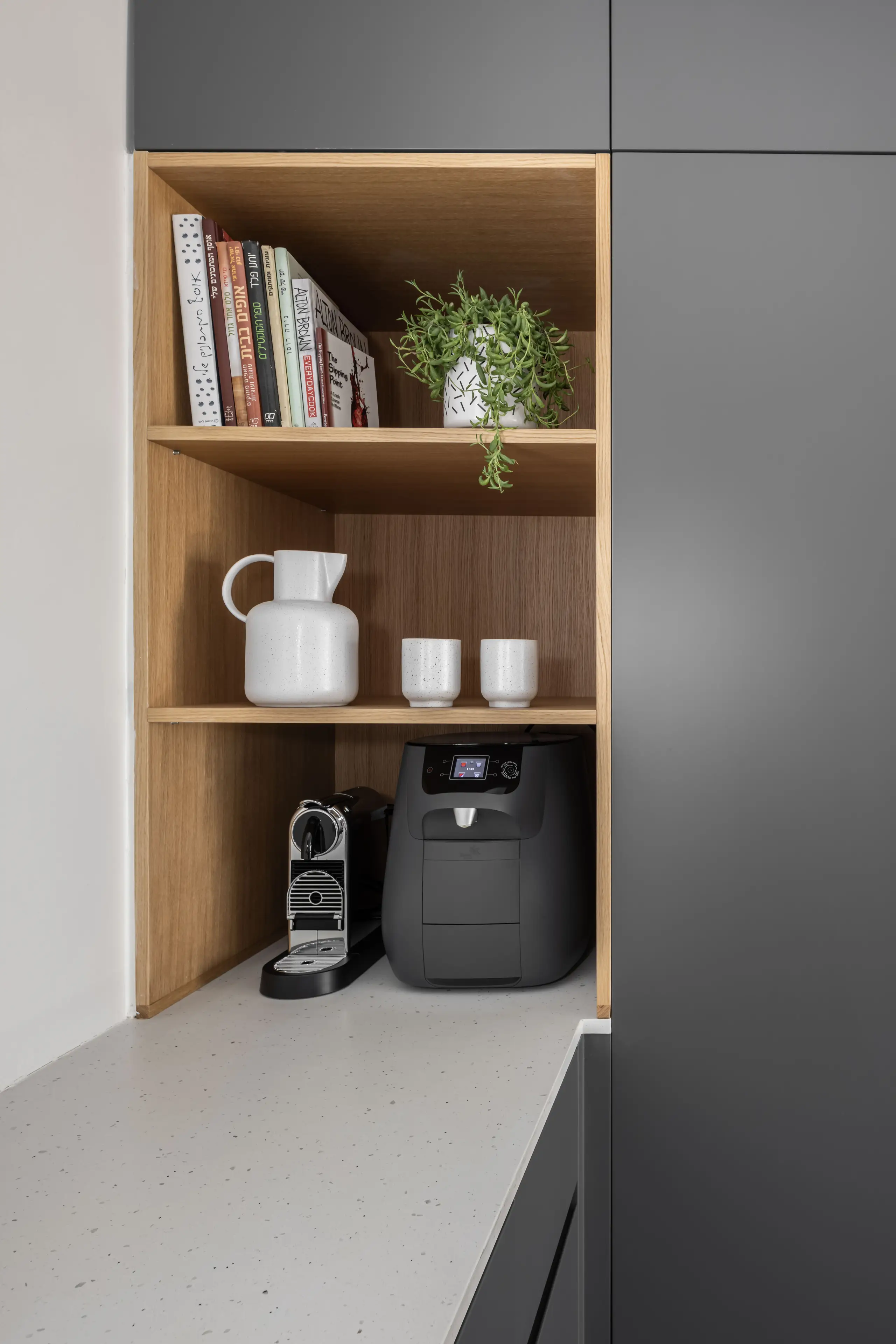 Oak shelving with a white jug, cups and a coffee machine
