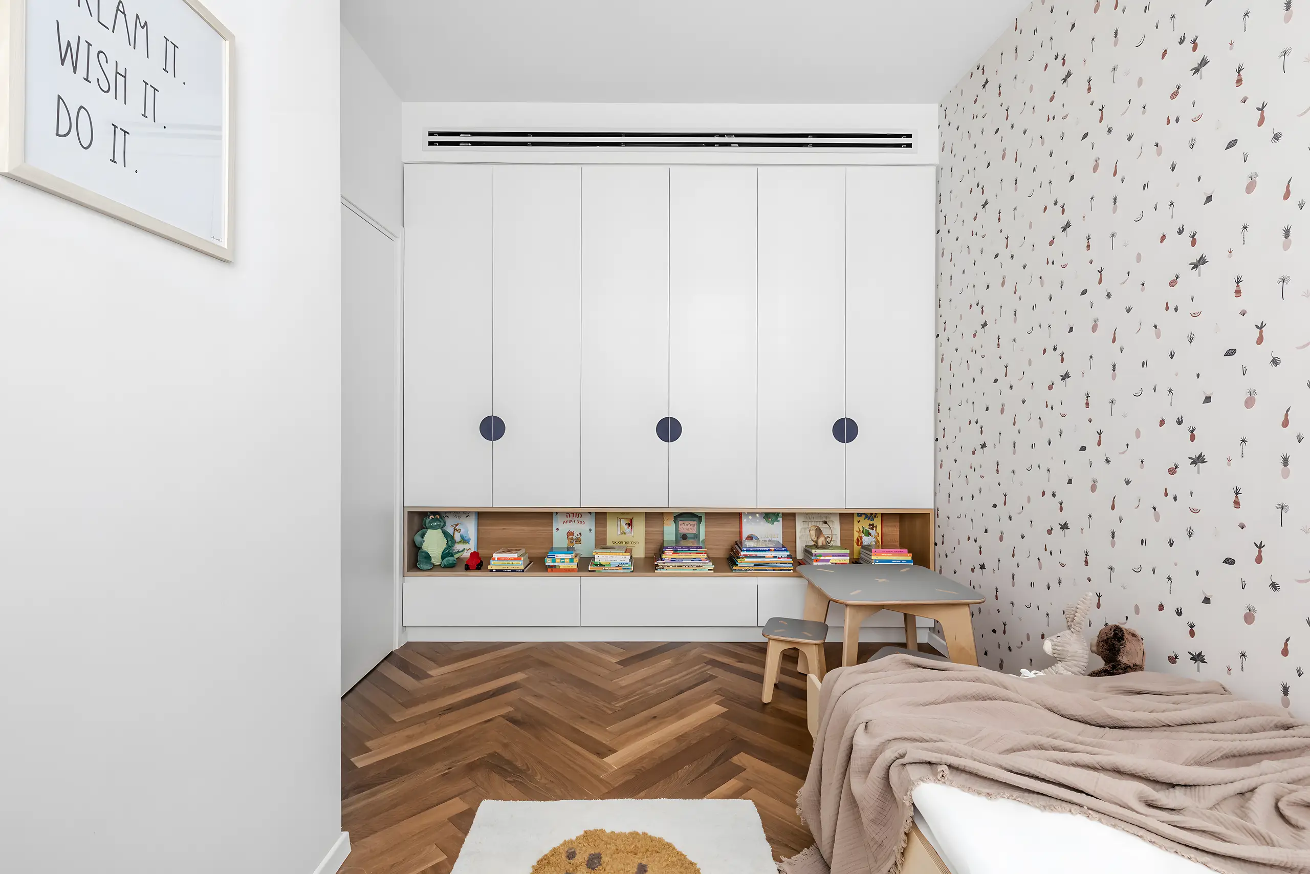 White storage wall with a bench in the child's room